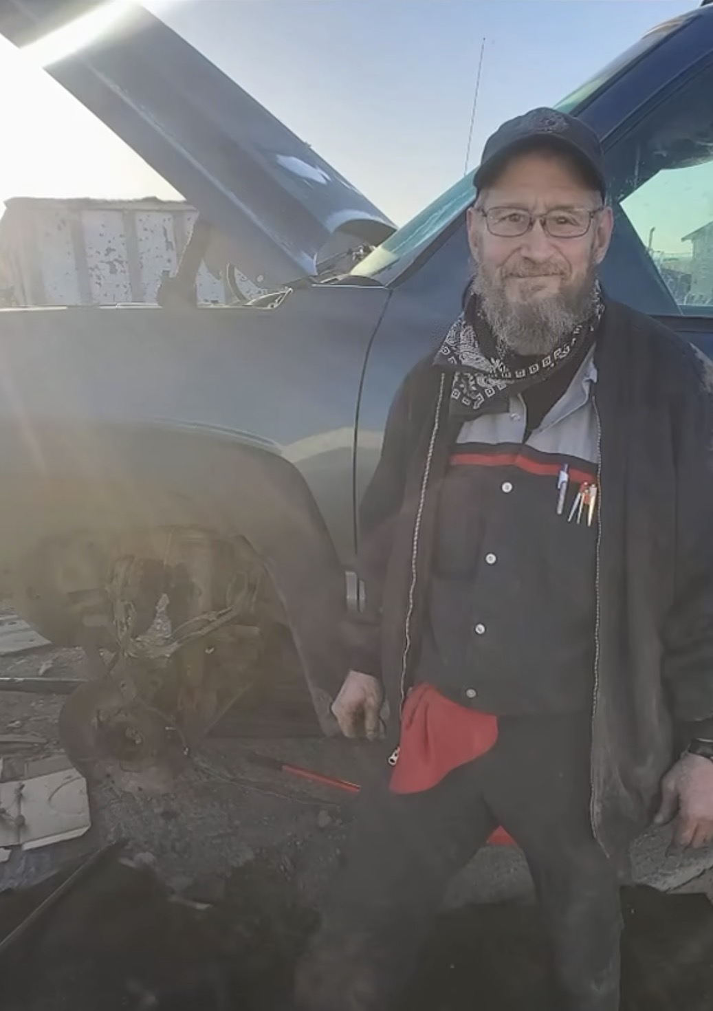 Derrell Nevil, owner of Recovery Automotive, standing beside a truck he is working on
